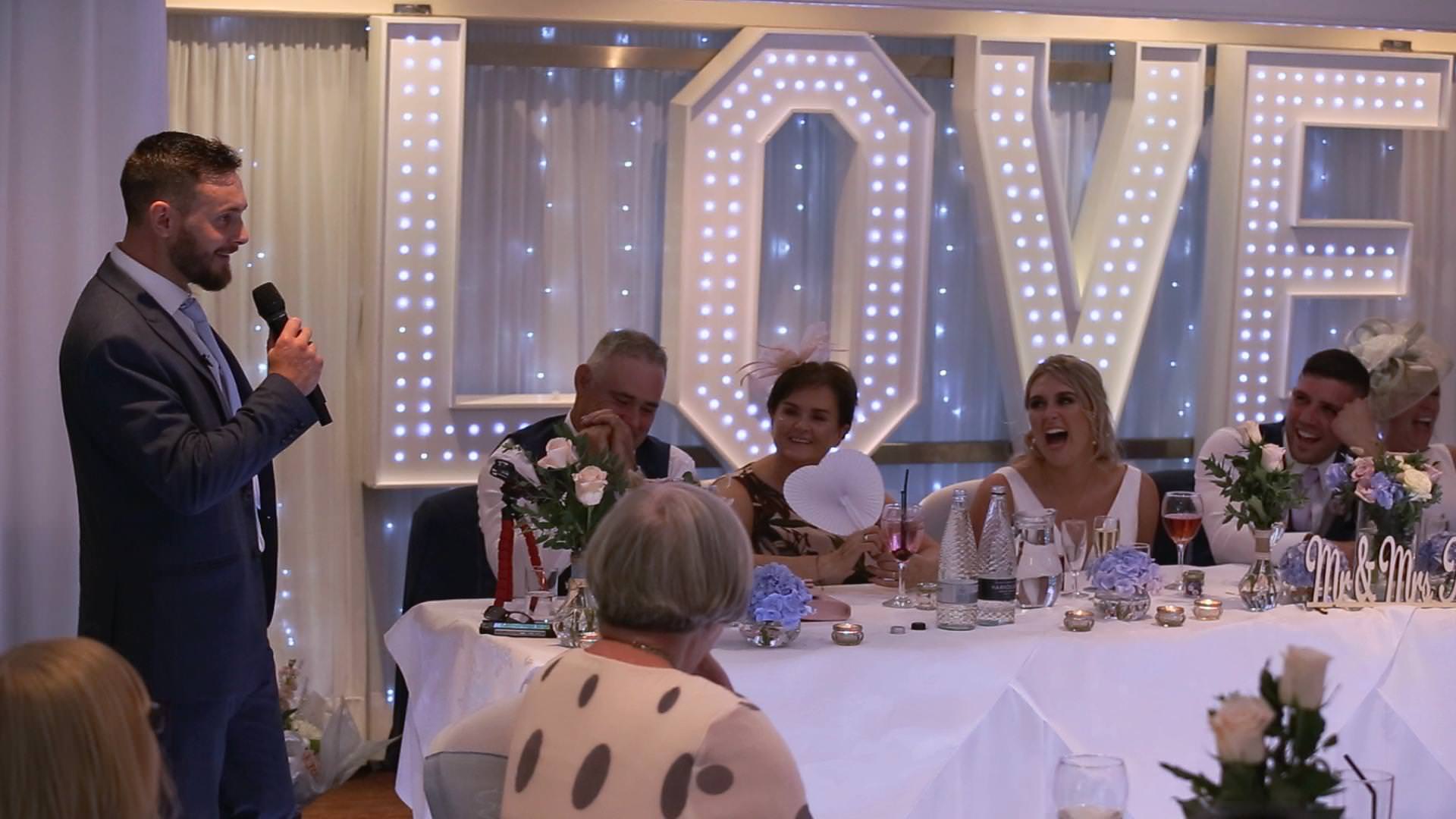 the top table laugh during wedding speeches in Lancashire