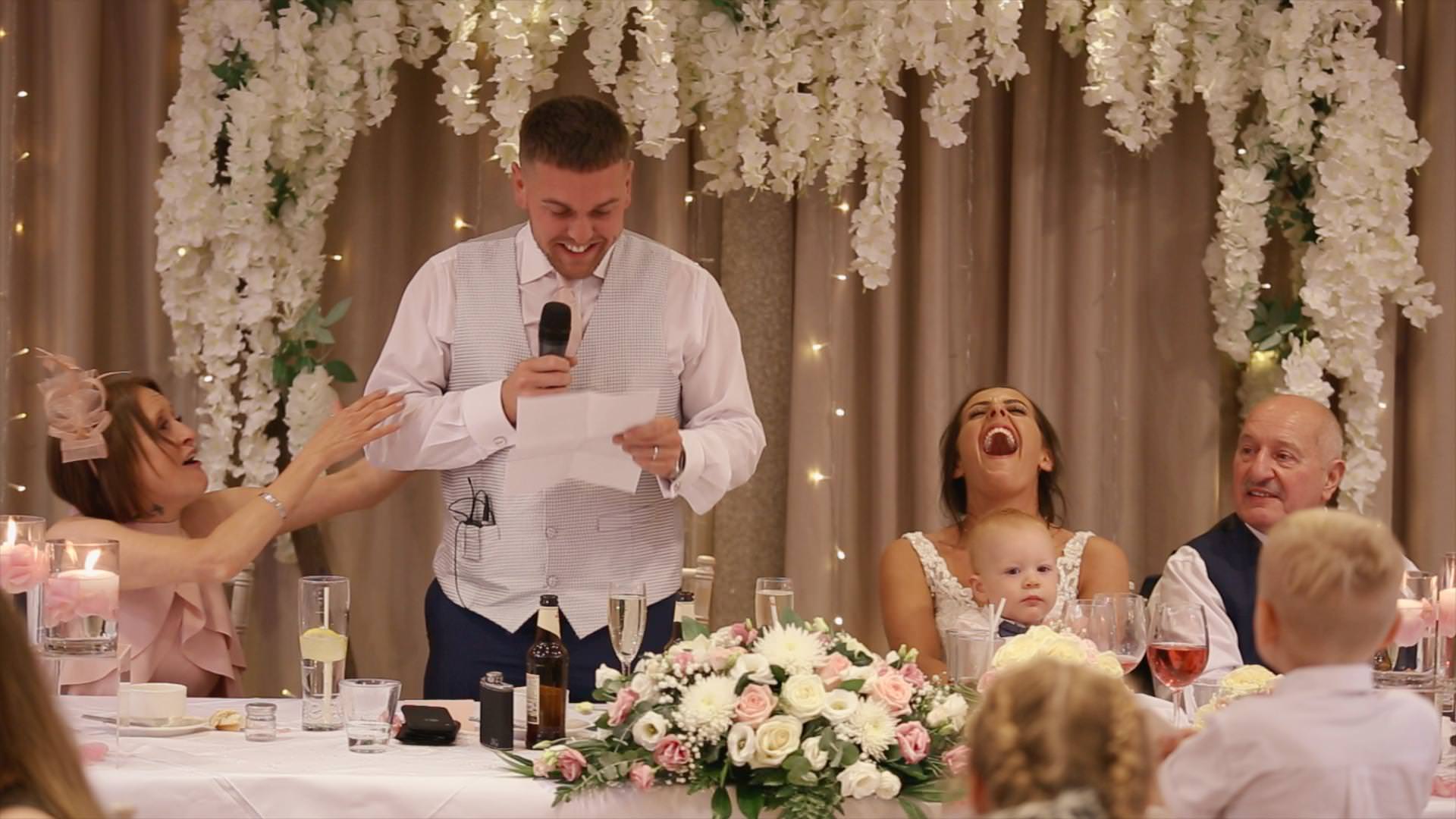 Bride laughs out loud during the grooms speech at Moddershall Oaks in Staffordshire