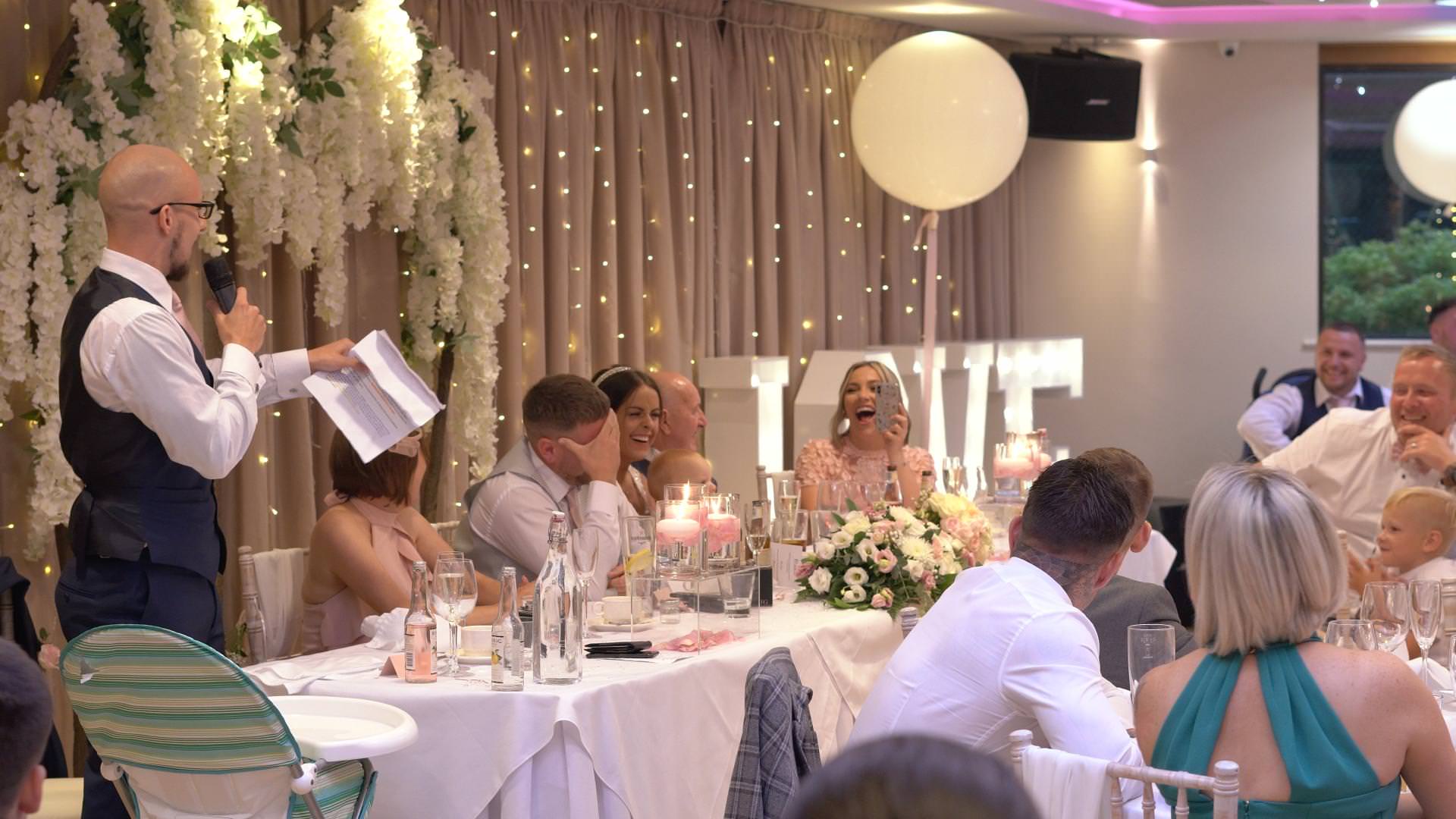 a wide video shot of a wedding reception and speeches at Moddershall Oaks