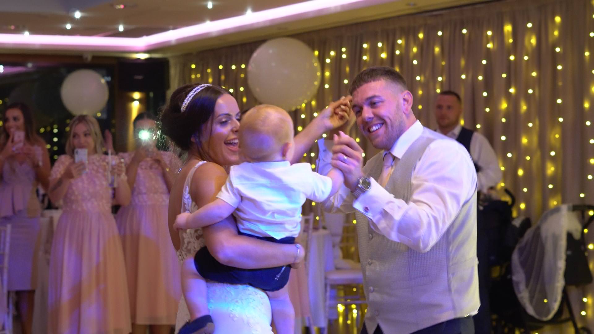 bride groom and son dance at their wedding at Moddershall Oaks