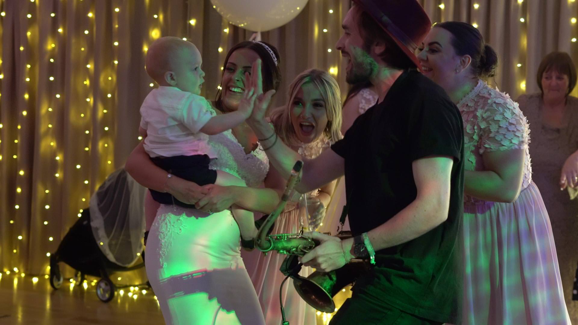 sax every weekend hi fives a page boy during a moddershall oaks wedding