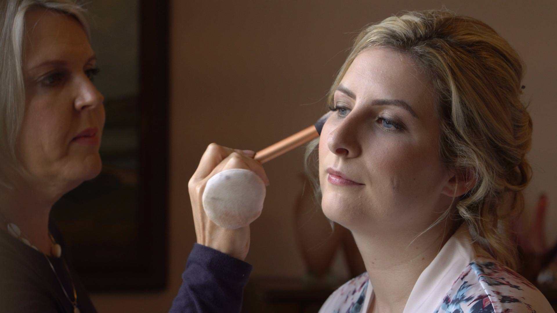 a bride gets her makeup done at Wyresdale Park