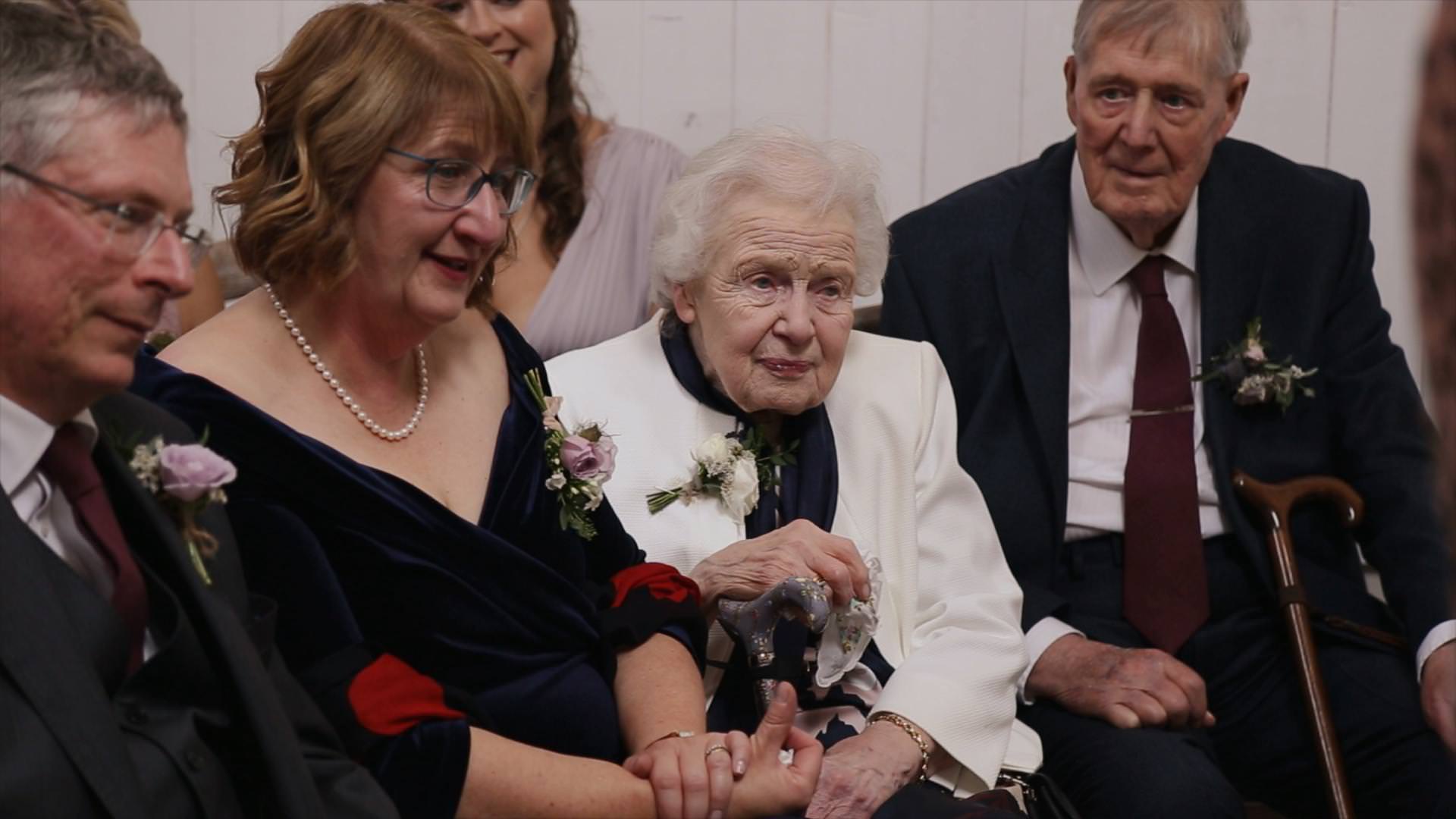 video still of a nan watching a wedding ceremony