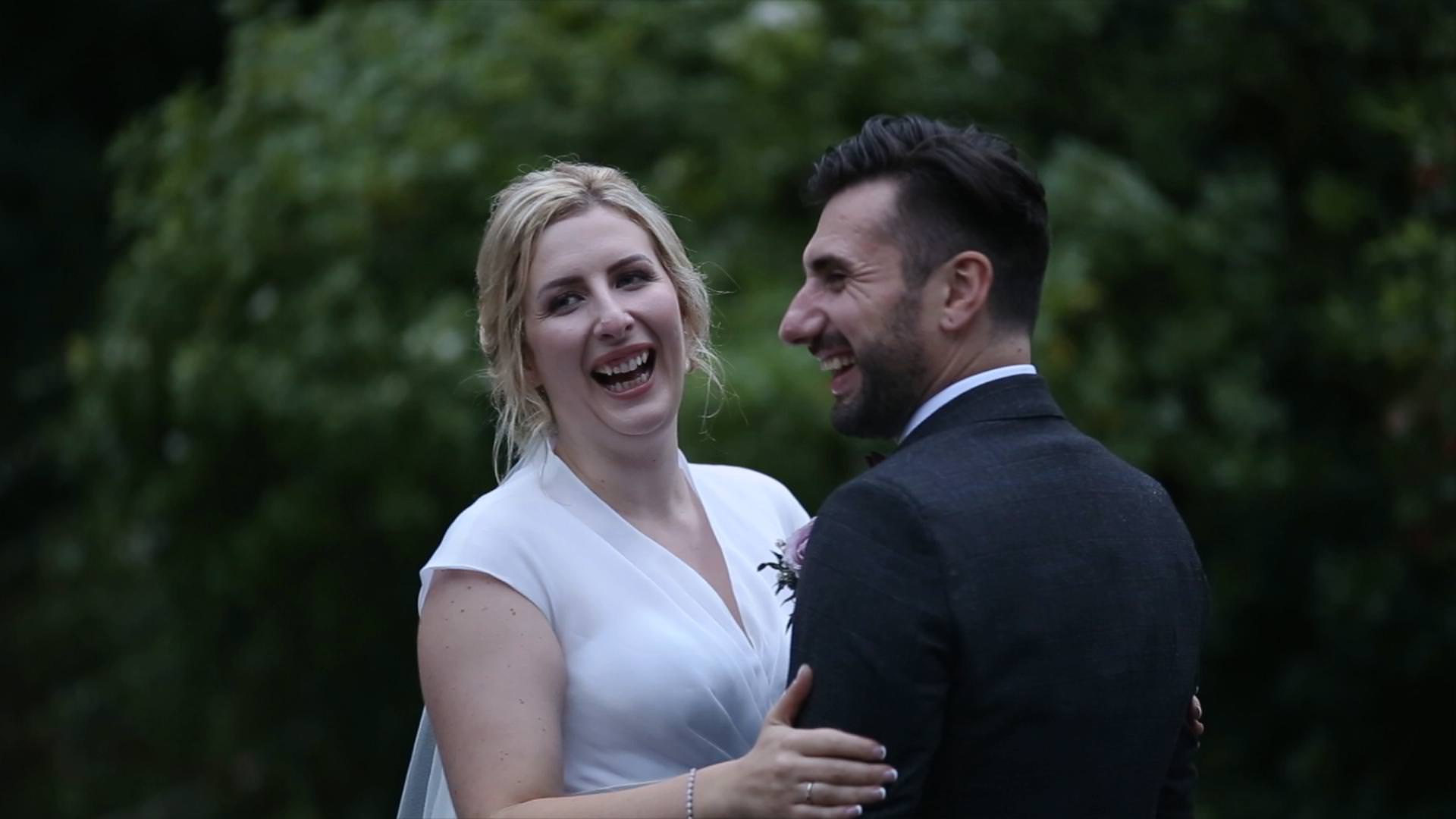 bride and groom laugh at each other during video couple shots