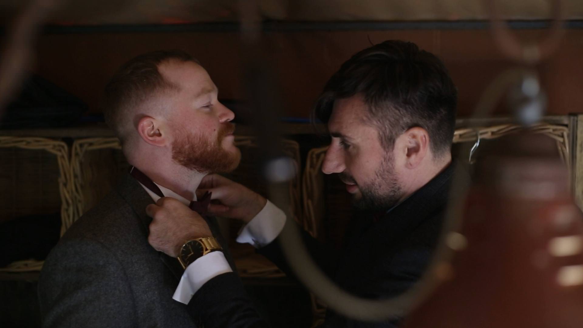 the groom sorts out a best mans bow tie