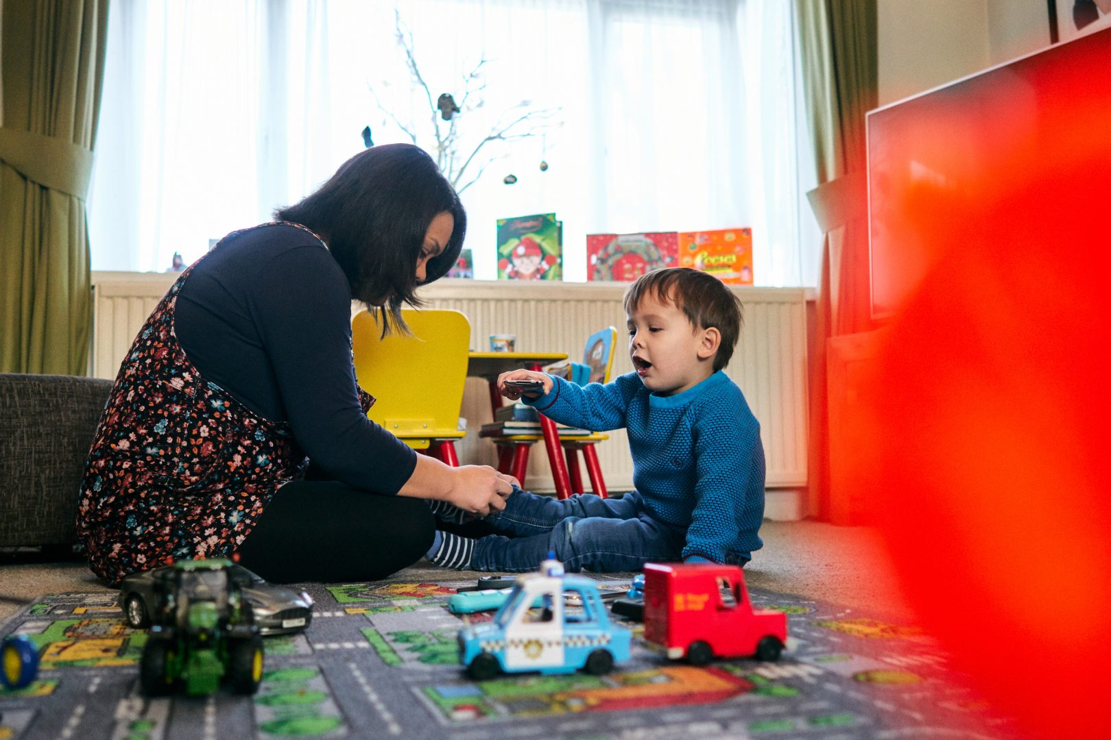 mum puts socks back on her son during photoshoot