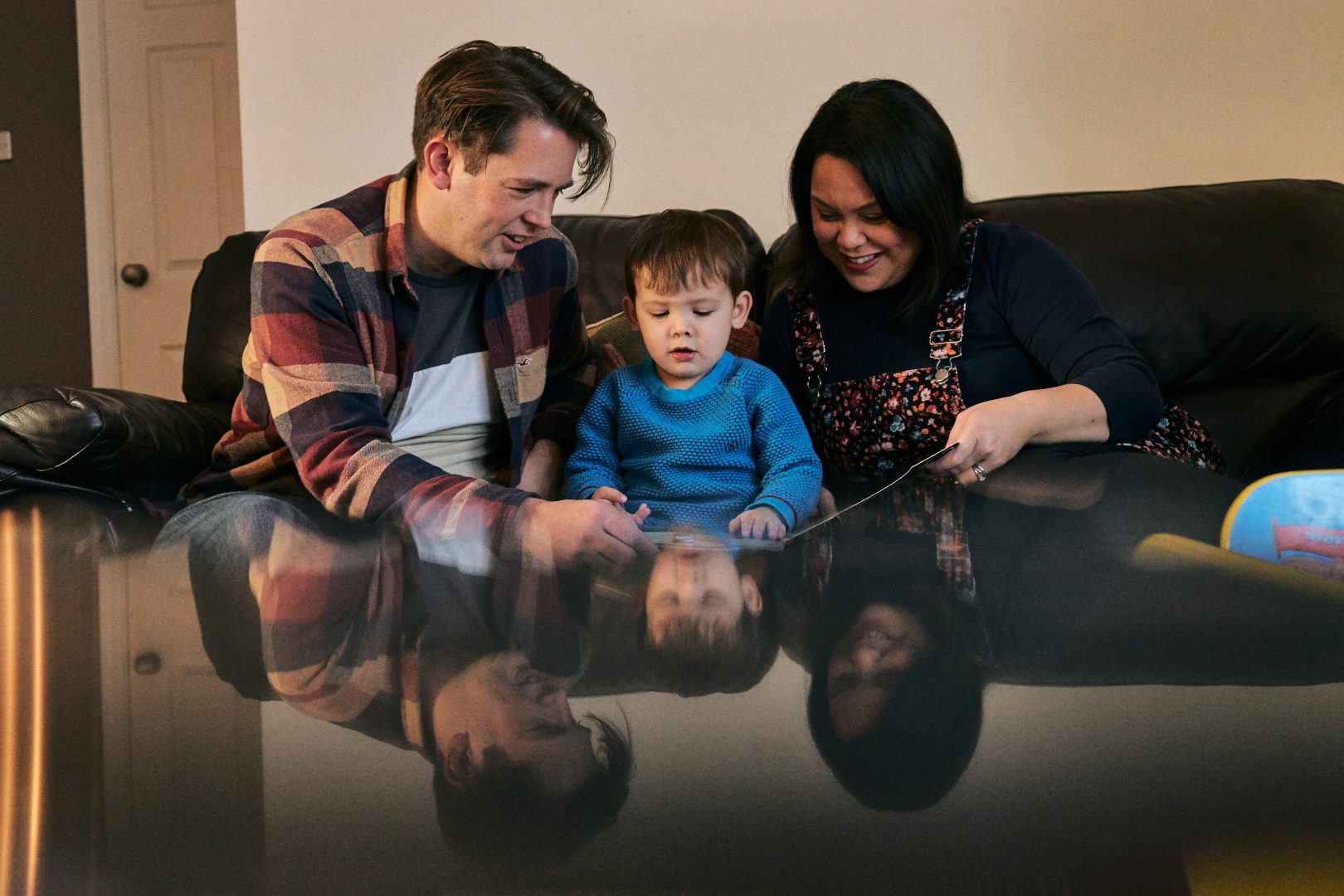 creative reflection shot using phone of family together at home