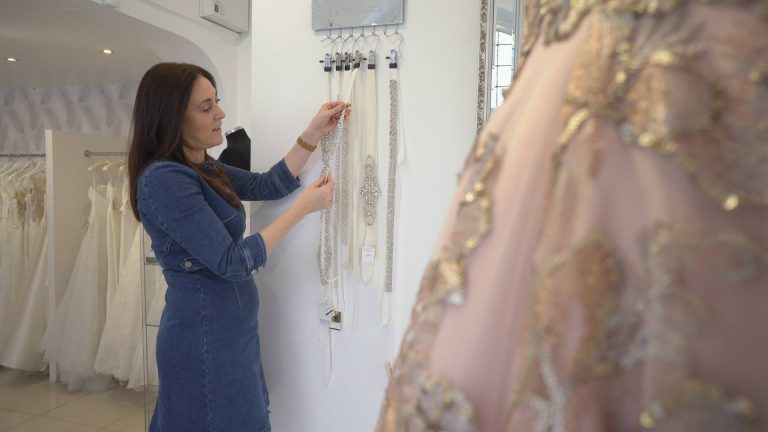 a bridal boutique owner looks at belts