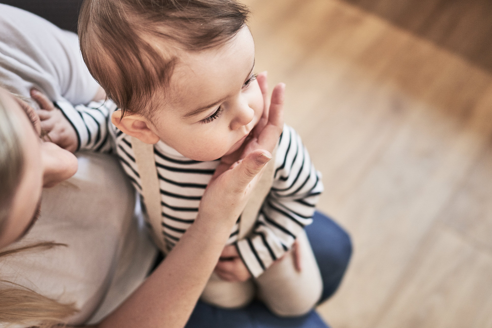 alternative family photograph of baby sat on mums knee