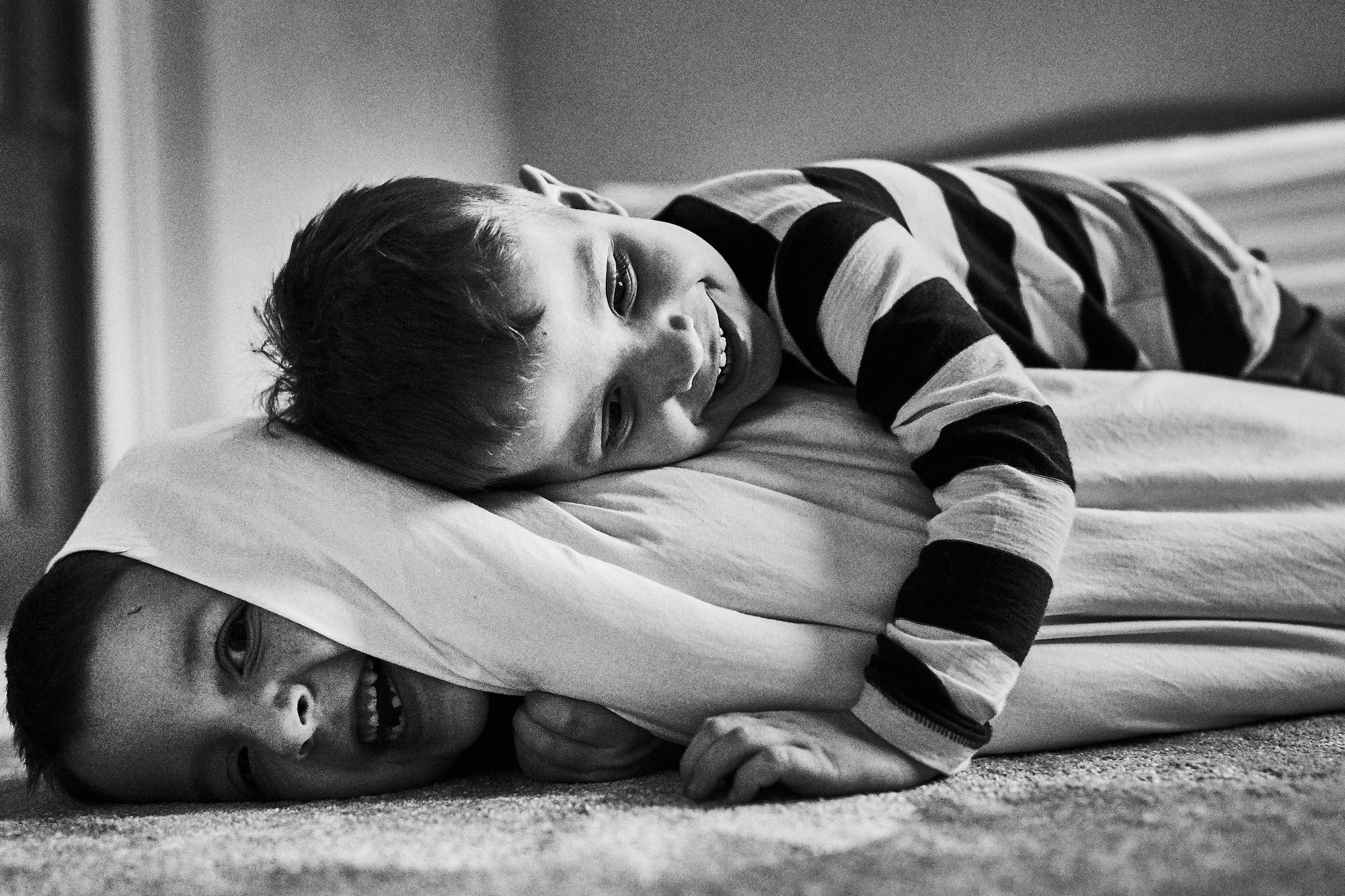 two boys play fight during family session in cheshire