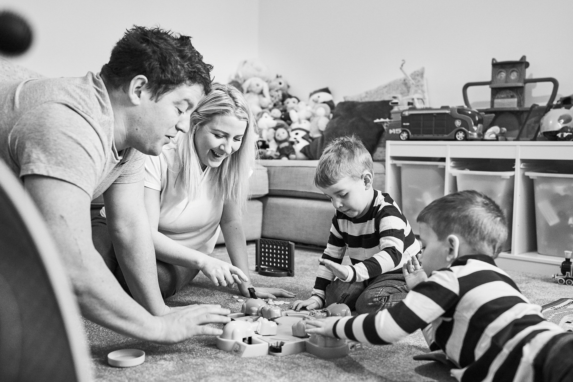 family play hungry hippos during photoshoot in cheshire