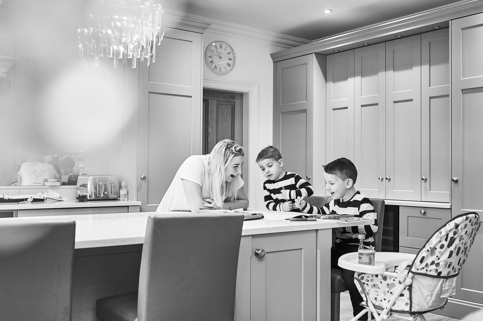 black and white documentary photo of family in kitchen