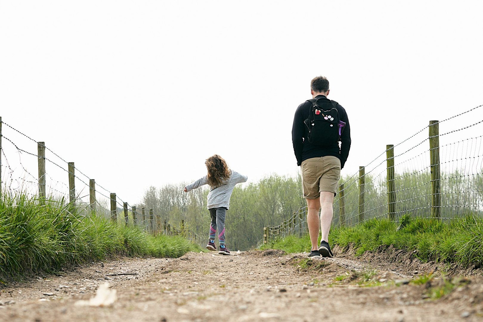 dad and daughter walk a country path in burscough