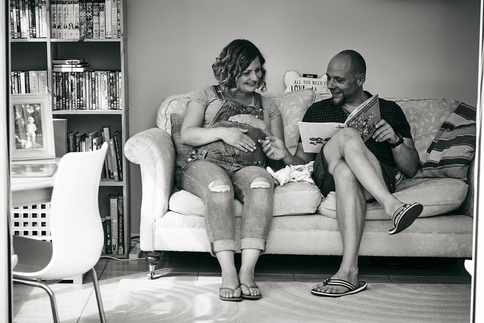 photo of couple reading to baby bump