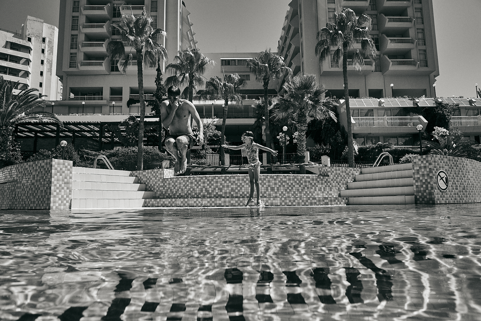 dad and daughter jump in swimming pool at Fantasia Kusadasi