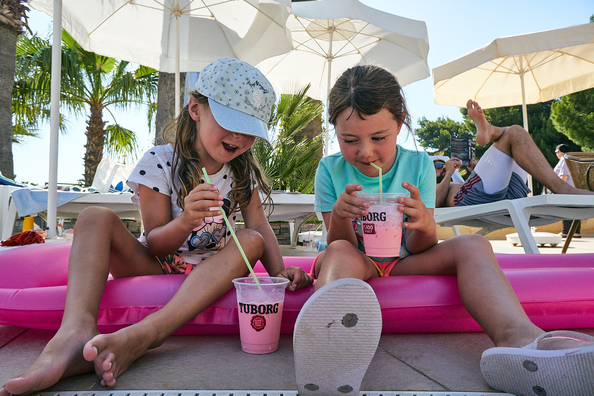 children drink by the pool on holiday