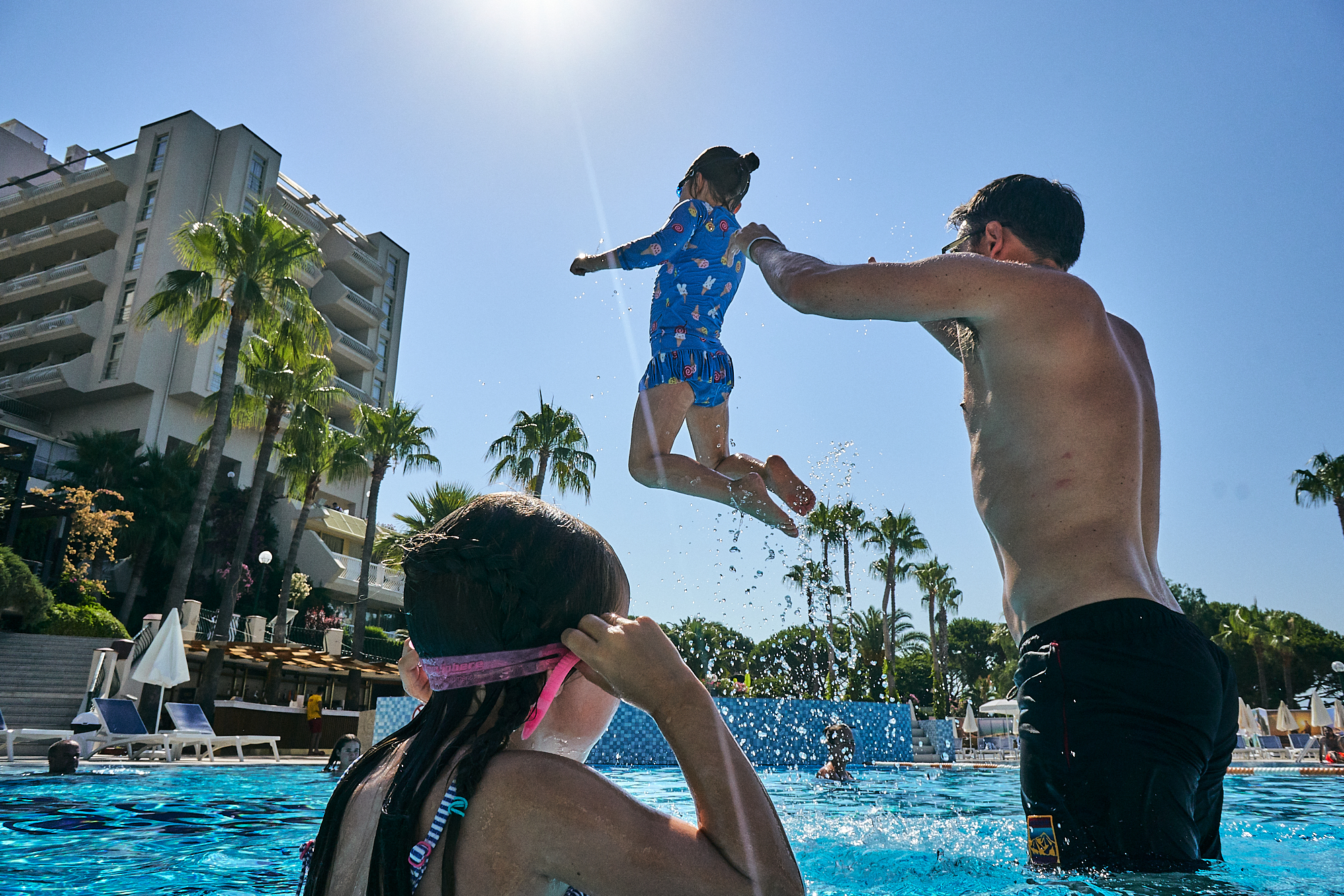 family playing in the pool at Fantasia Hotel