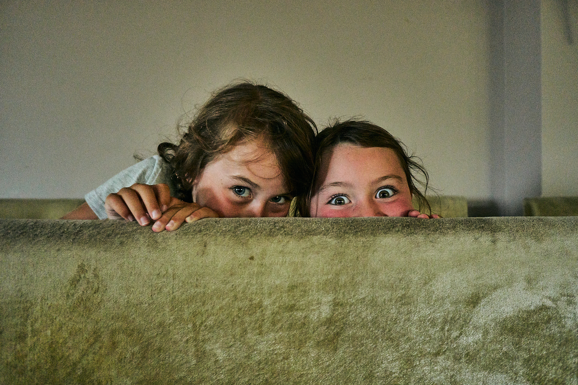 two girls pretend to hide from the camera