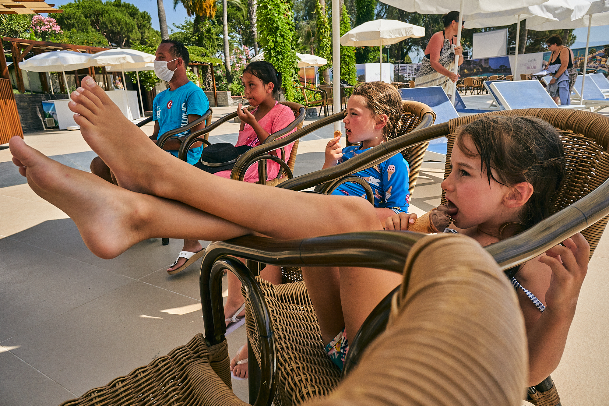 girl sits and licks icecream on holiday