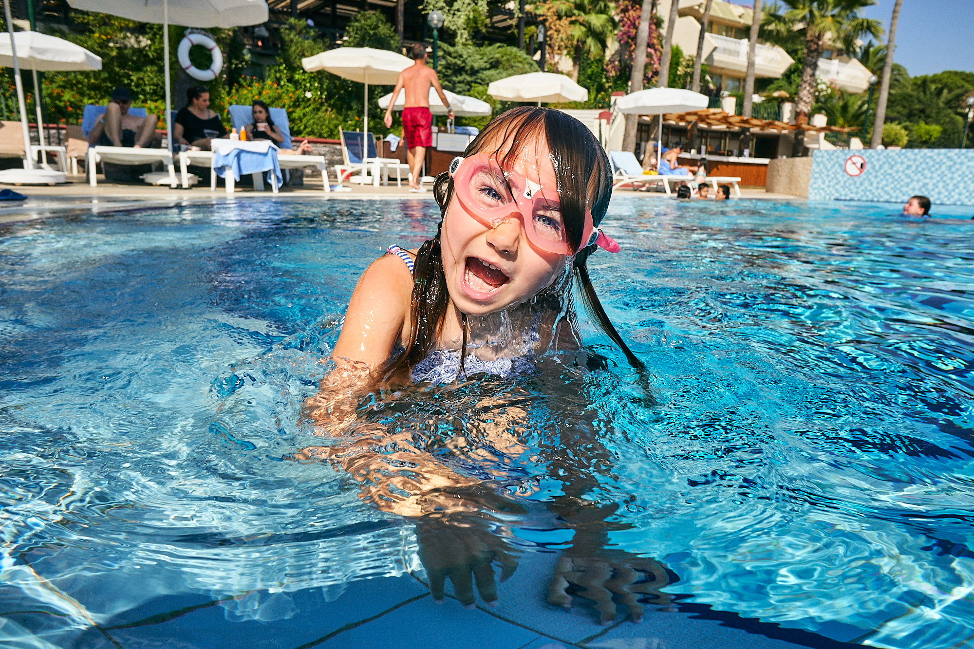 fun picture of girl pulling face in holiday pool