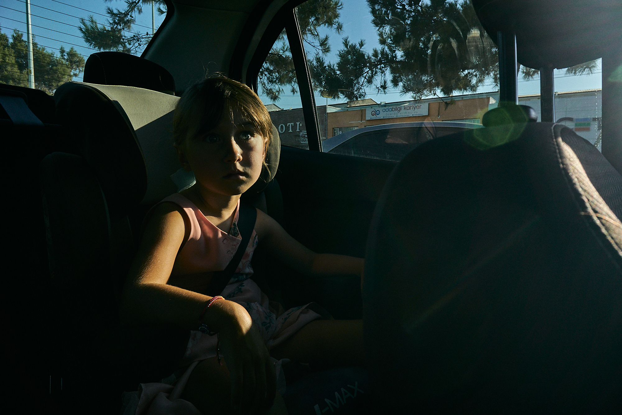 girl sat in hire car in the sun light
