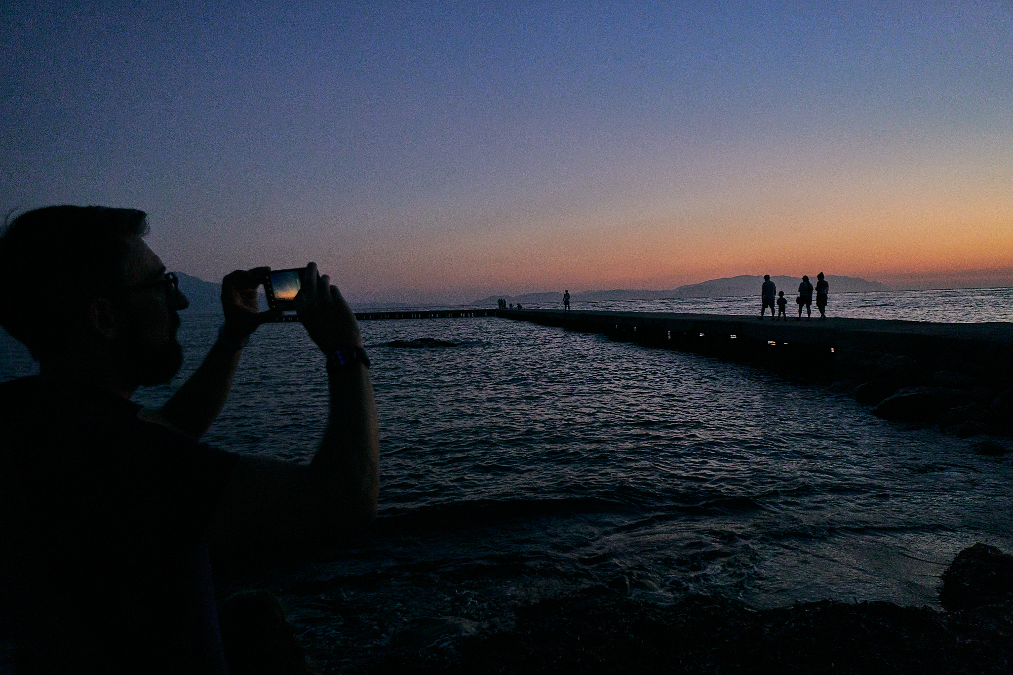 taking a photograph of the sunset in Kusadasi
