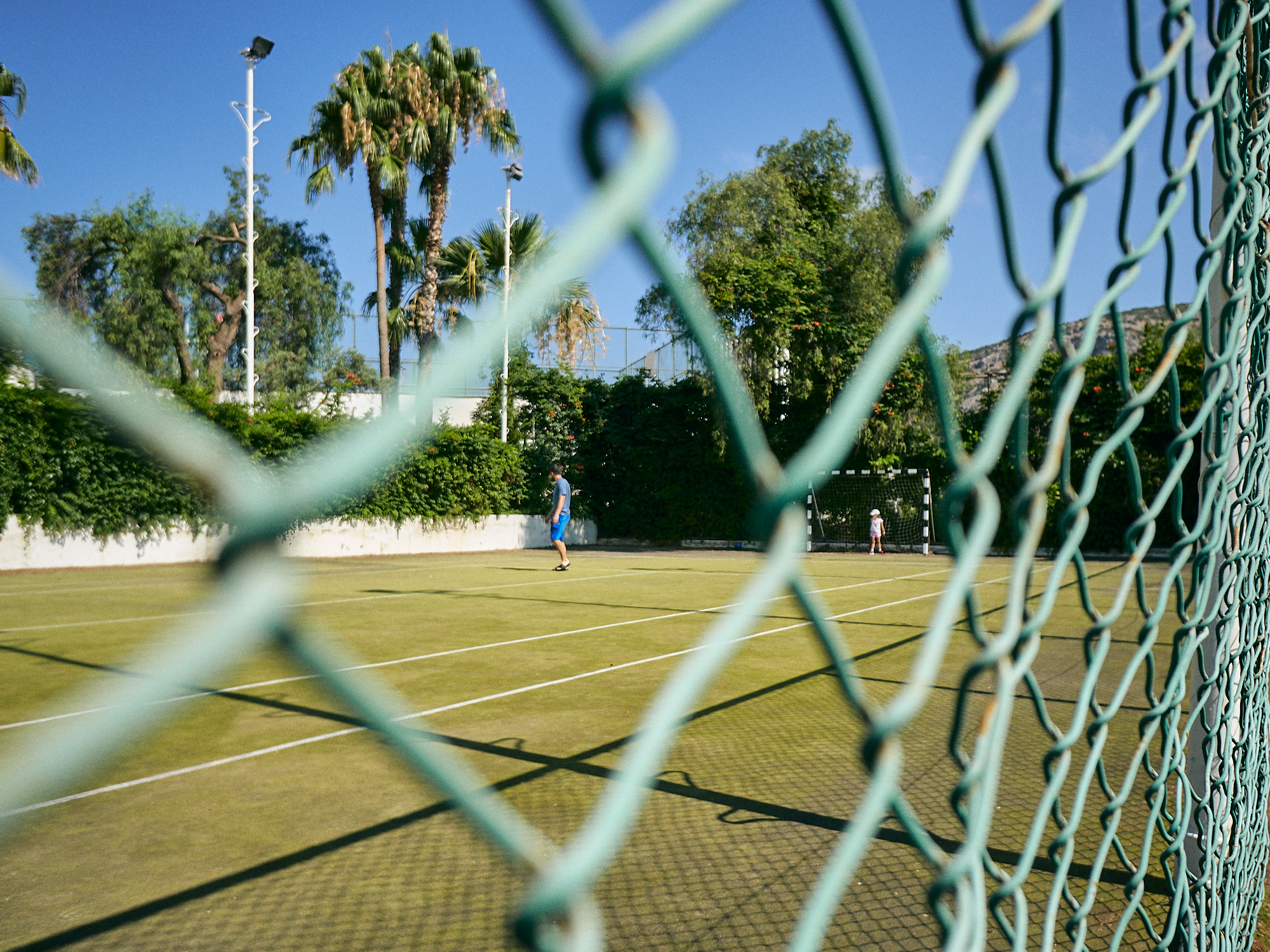 family play on empty sport court during coronavirus
