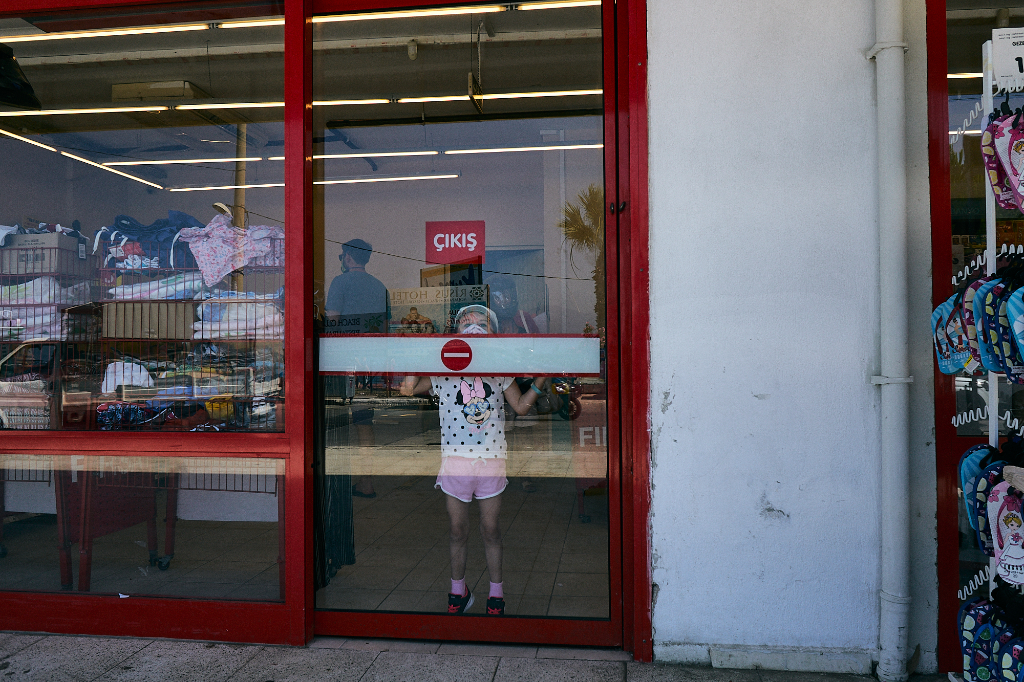 young girl in mask inside shop in Turkey