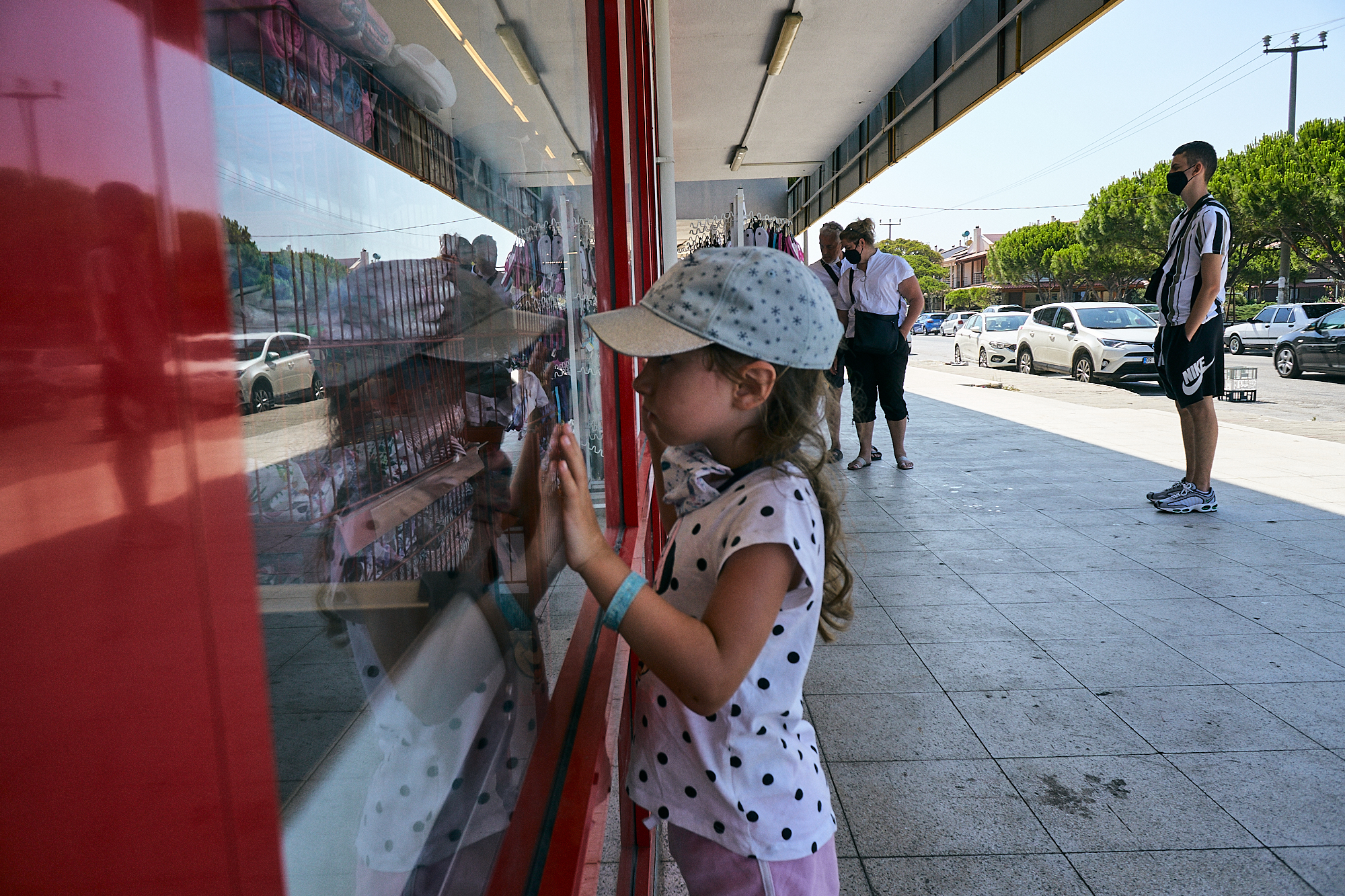 girl looks in shop window during covid19 in Kusadasi