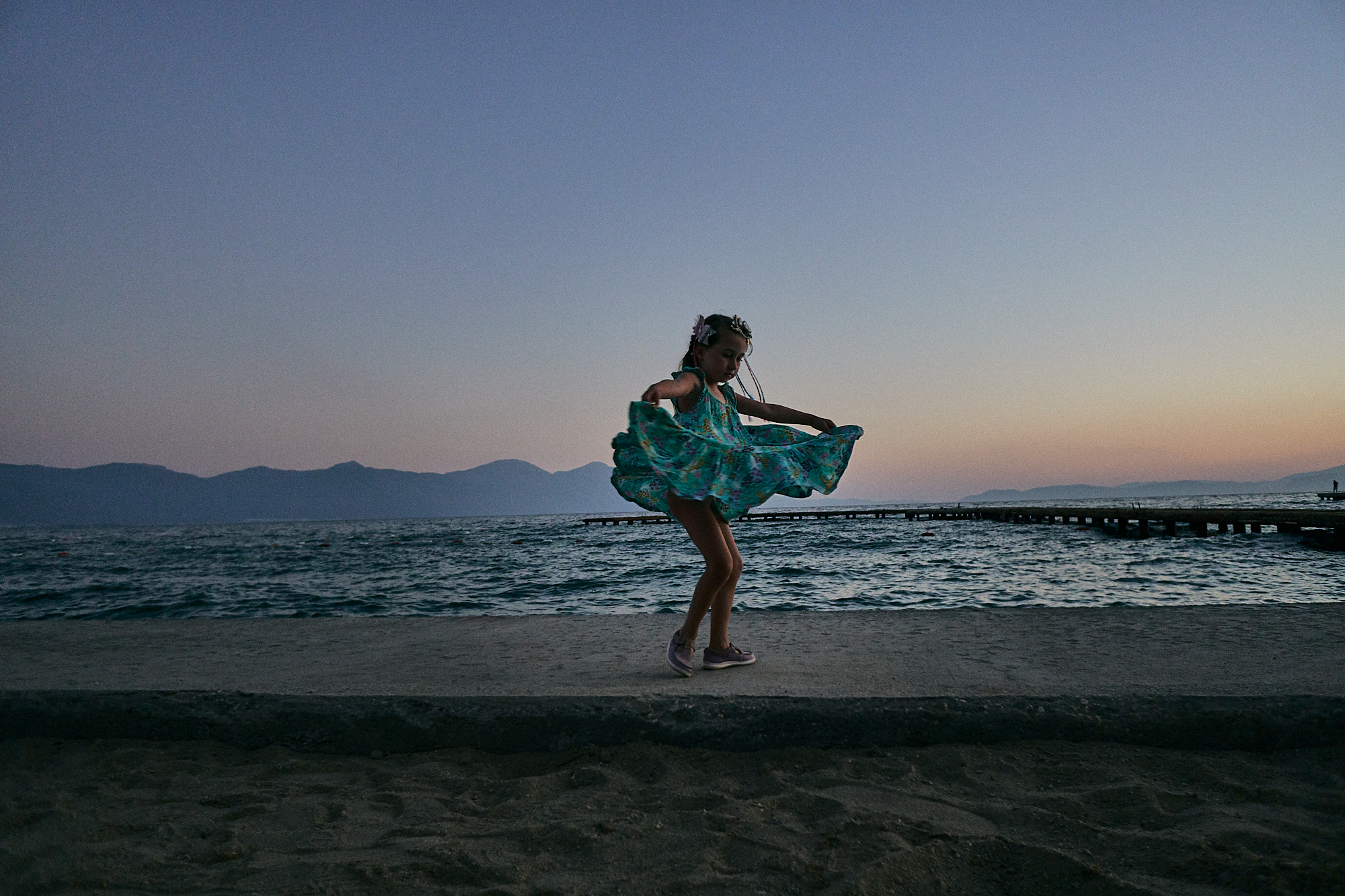 girl spins in dress during sunset
