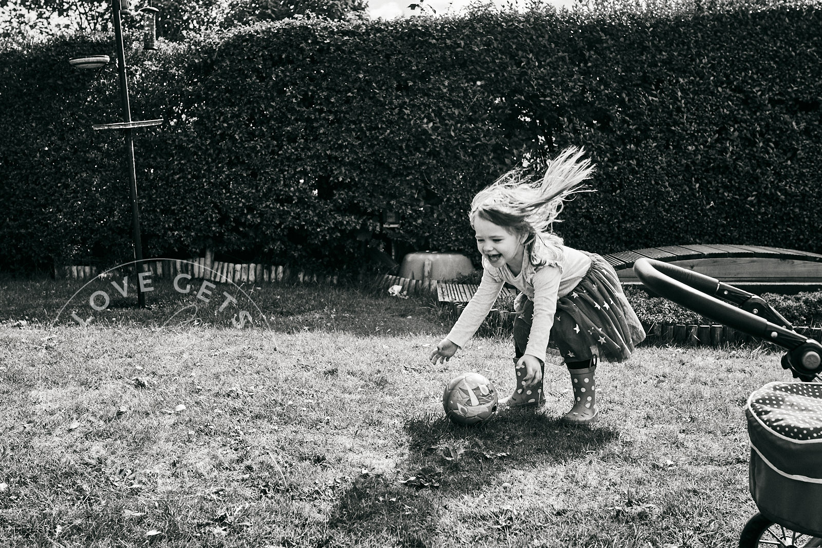 little girl playing with ball during family photoshoot lancashire