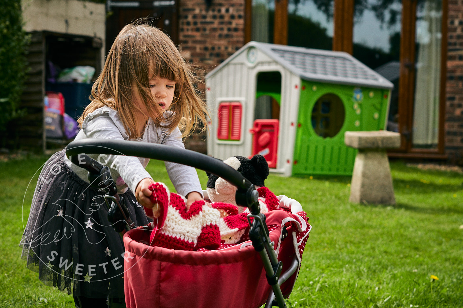 photo of girl with jessie cat and pram during family photoshoot