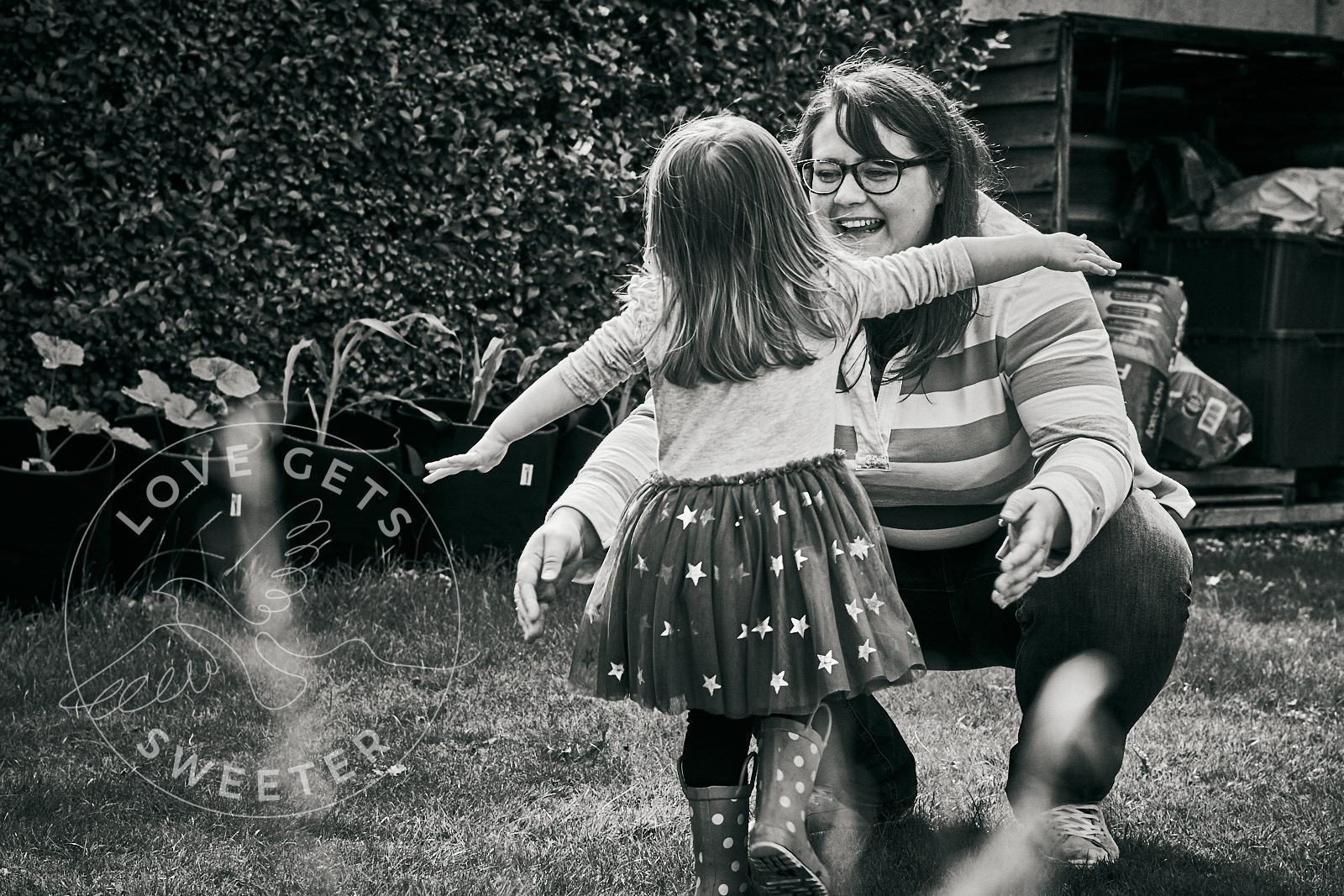 girl runs to mum for a hug during family photography shoot