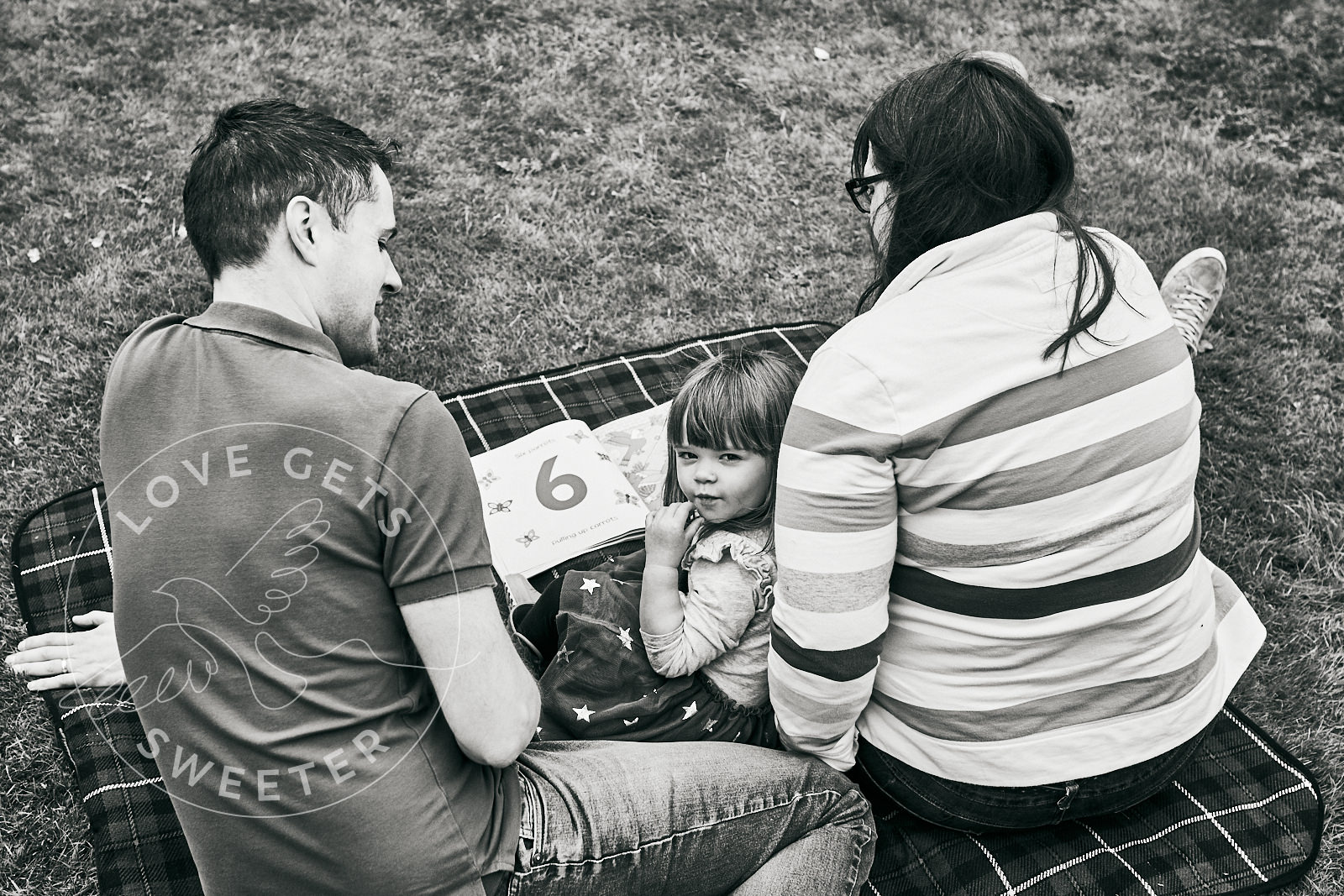 family reading on blanket during natural family shoot