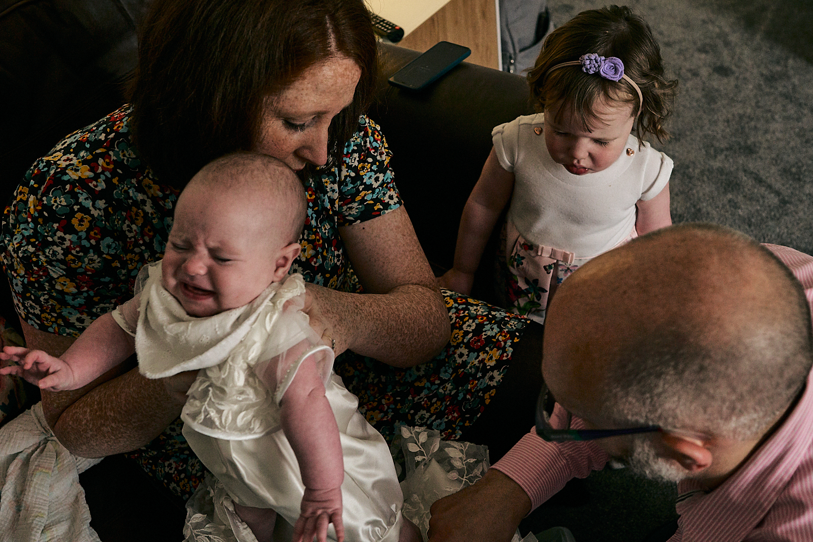 baby cries getting ready for naming ceremony in wedding dress gown