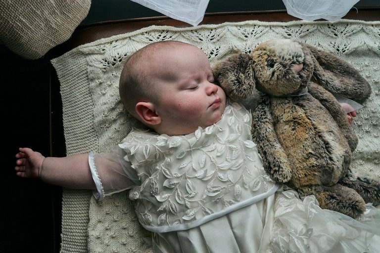photo of baby asleep in naming gown