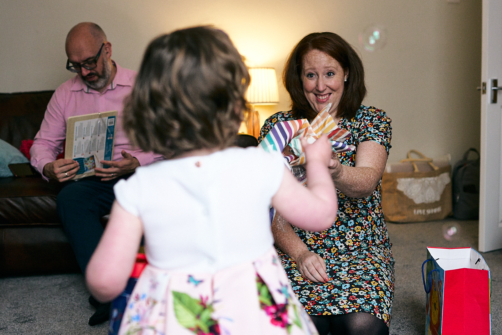 photo of happy mum giving out christening gifts