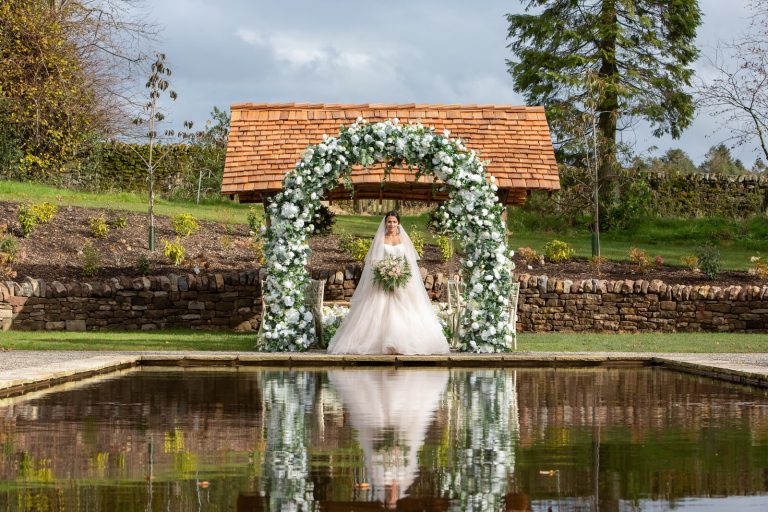 Beautiful ceremony at lily pond Browsholme Hall and Barn
