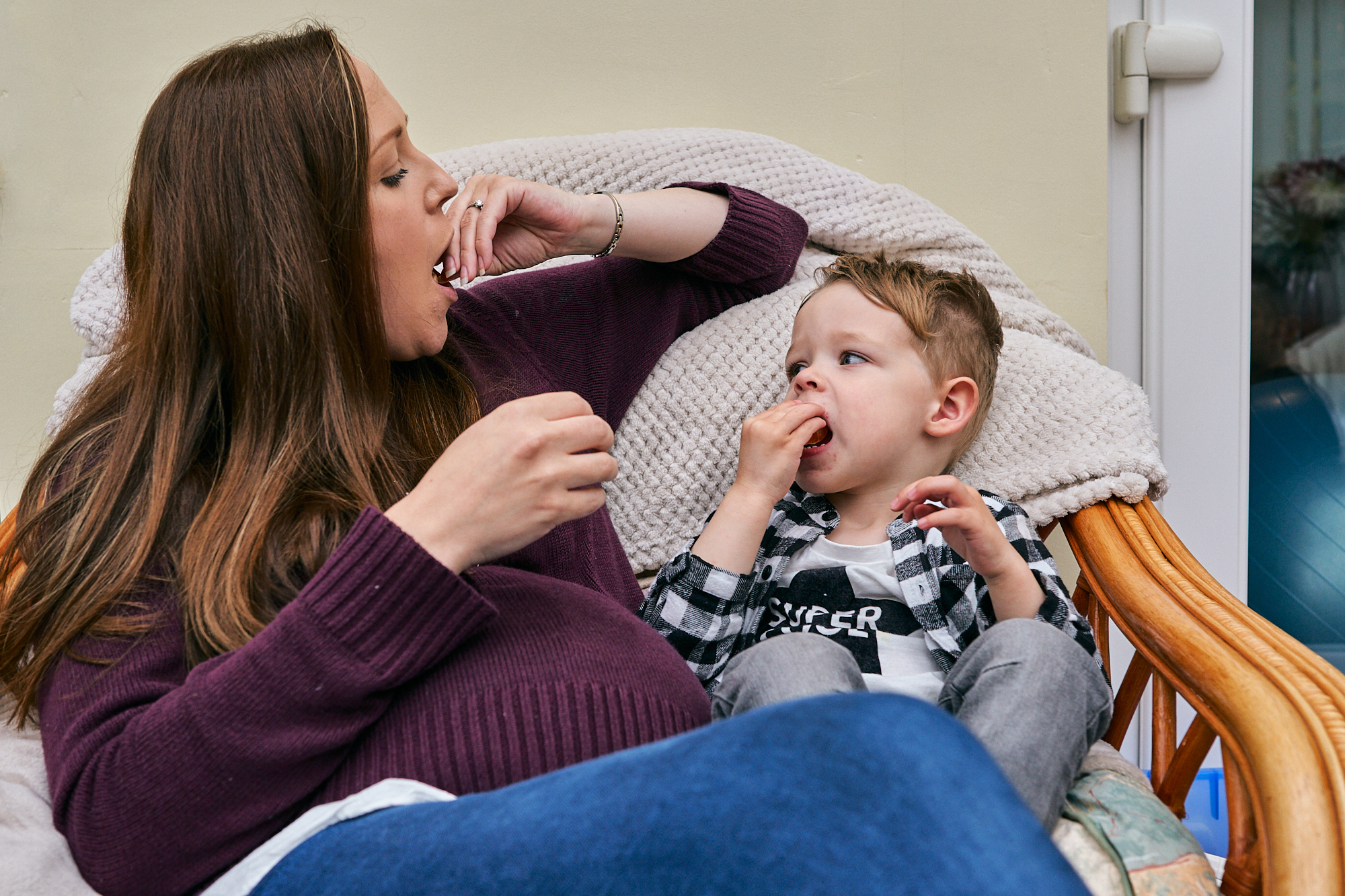 mum and boy mirroring eating pose for photo