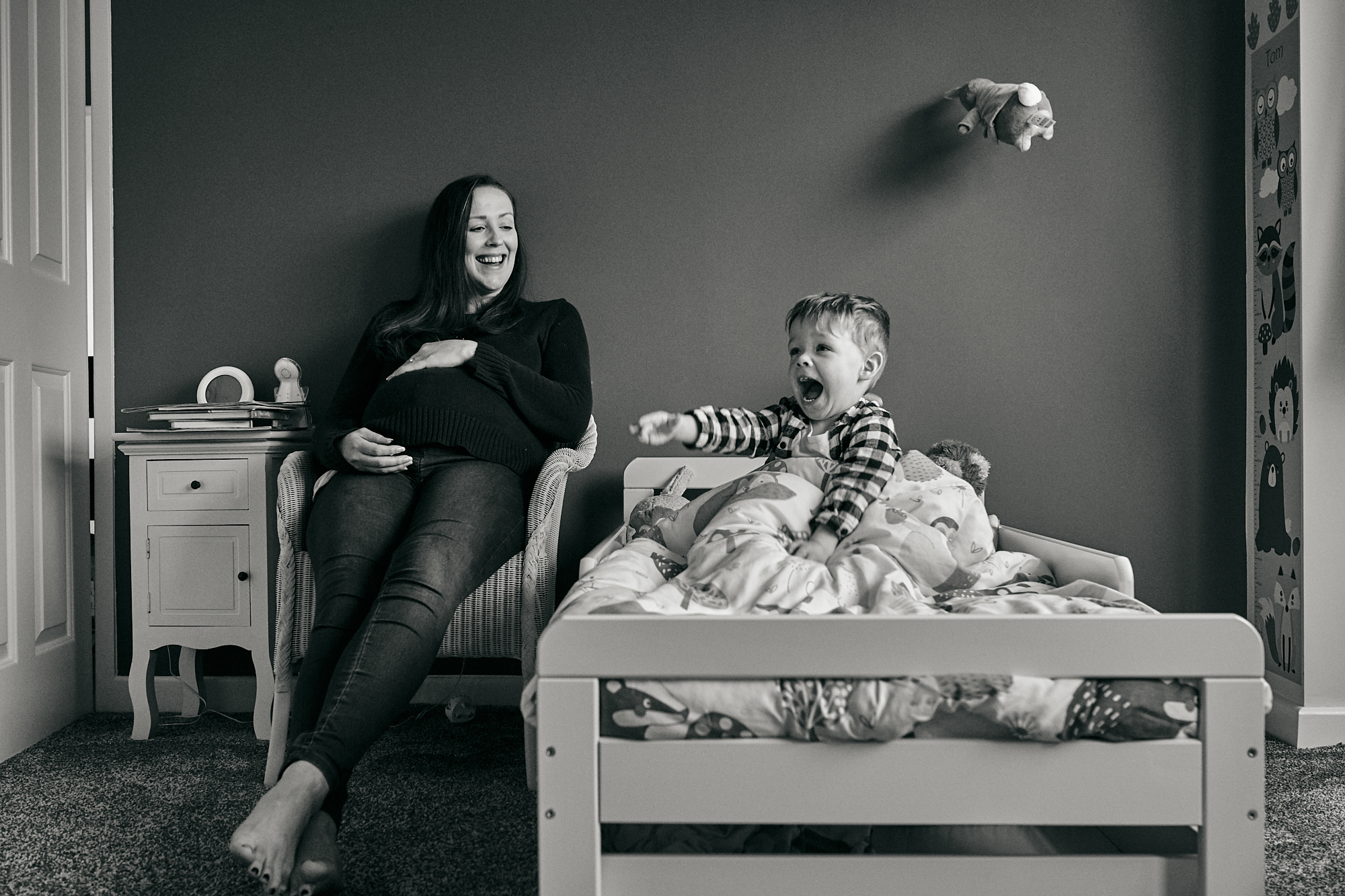 fun candid photo of mum, bump and son having fun during photoshoot