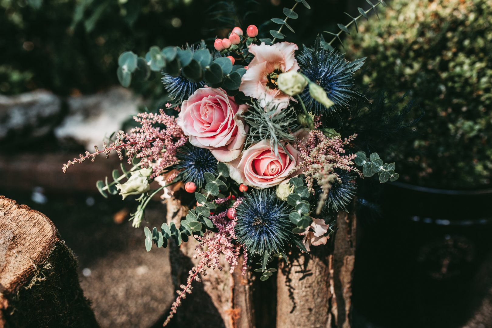 beautiful pink and blue bridal bouquet on log