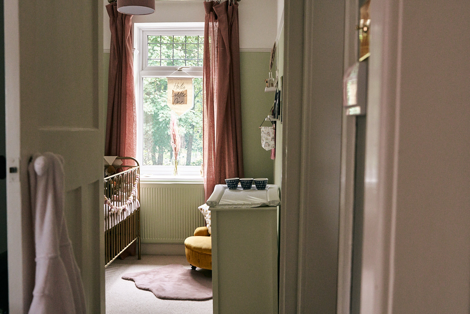 bright dusty pink and mint green baby nursery on photoshoot