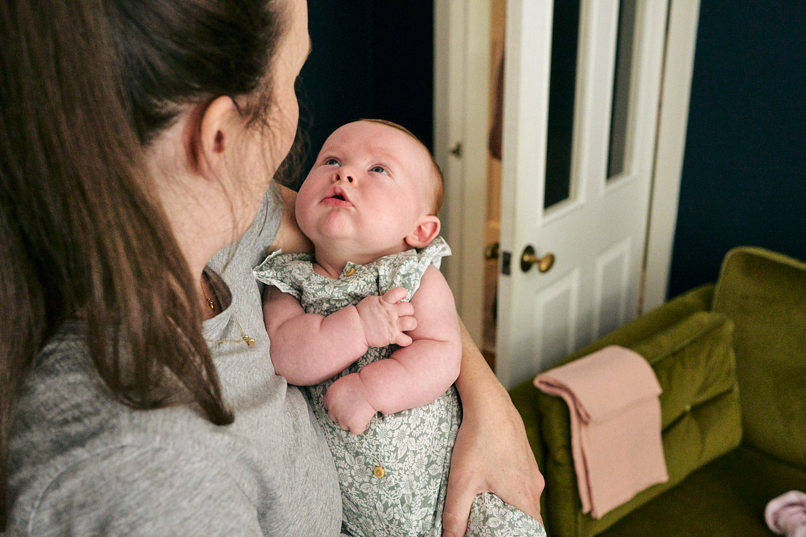 mum holds baby girl during family photoshoot