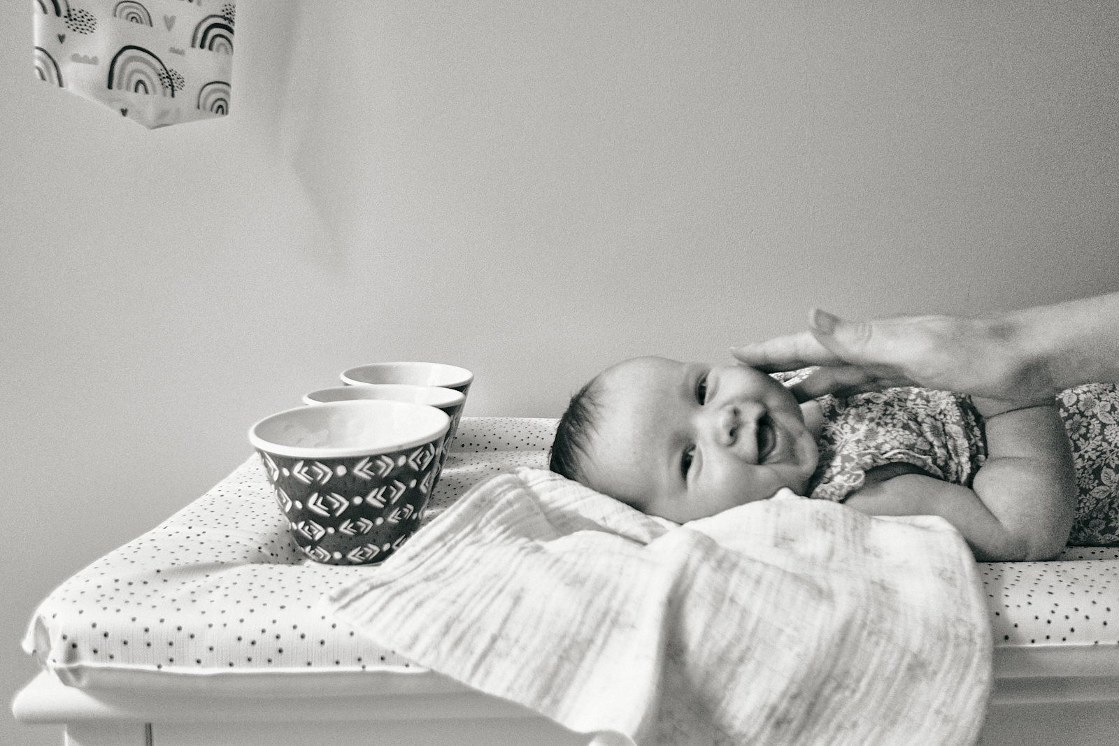 baby laughing on changing mat at home