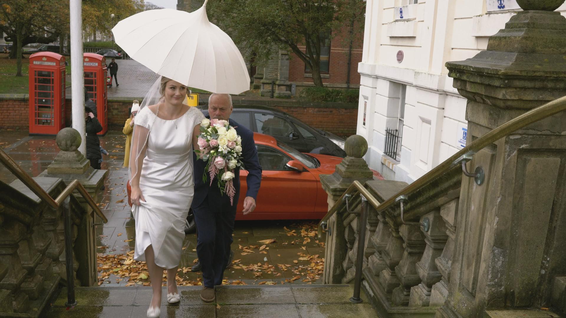 a bride arrives in the rain at Southport town hall