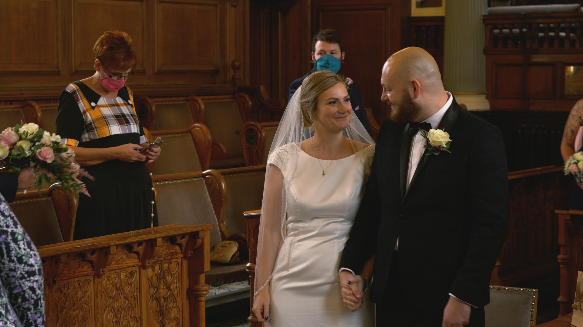 bride and groom smile during a small ceremony at Southport town hall