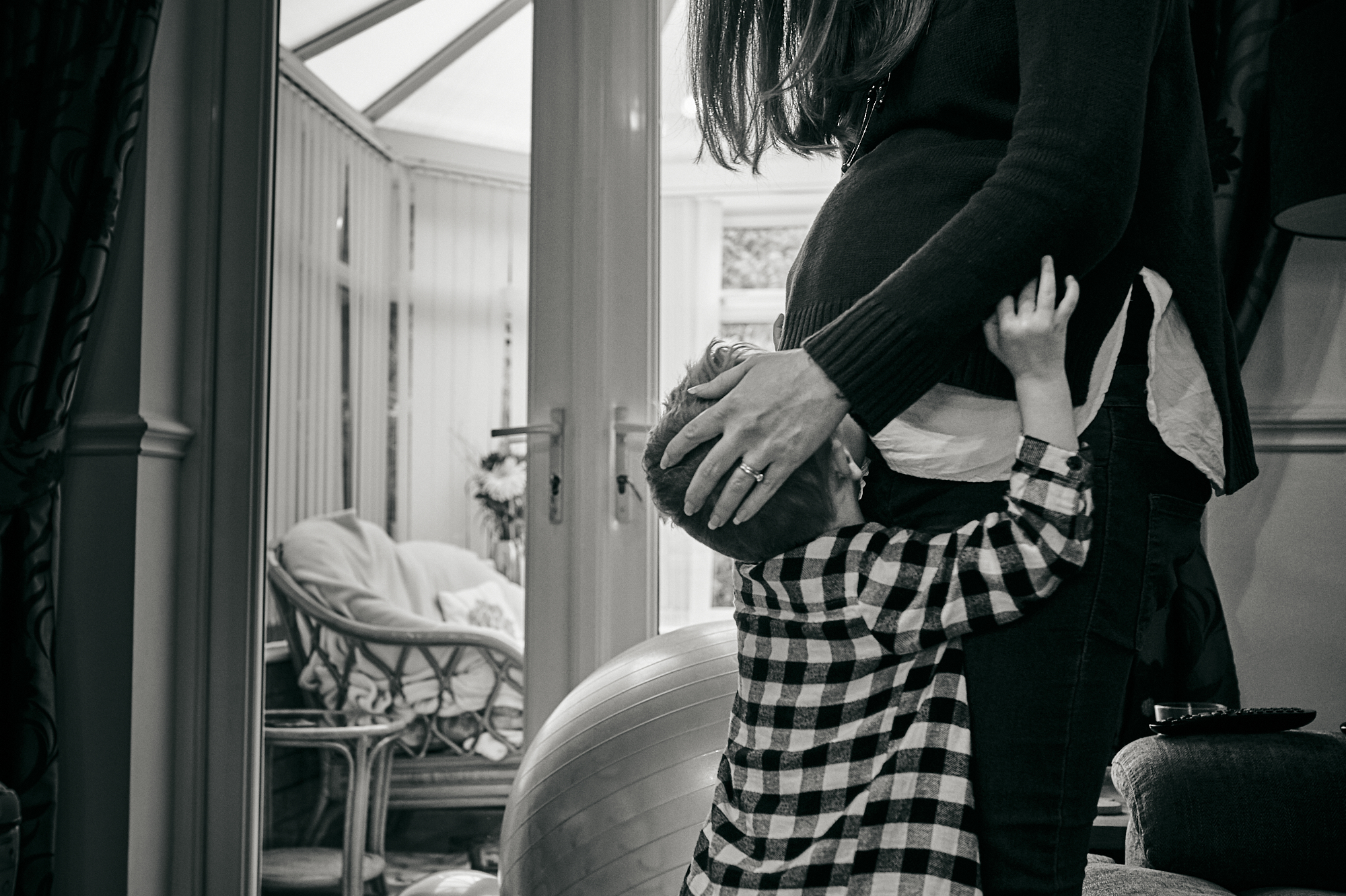 child kisses mums bump photograph