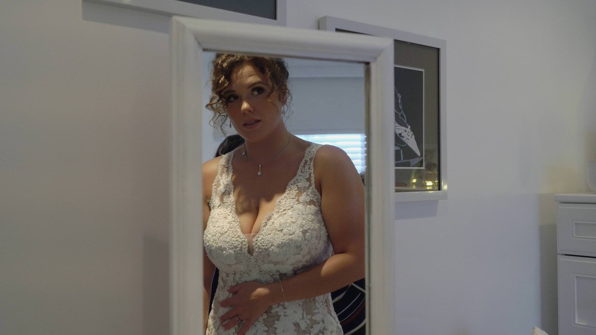 video still of bride getting ready in mirror at home in preston