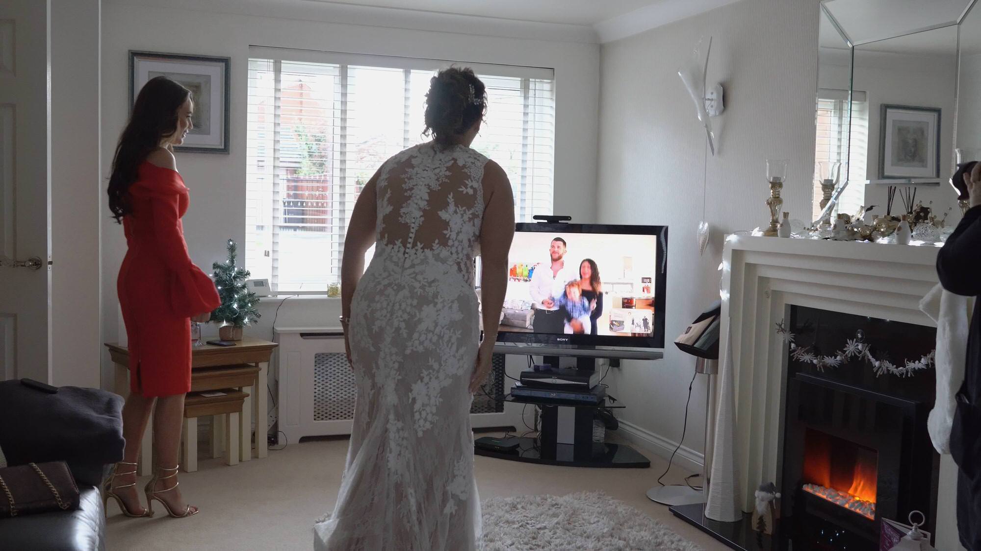 bride shows off dress to brother virtually on Facebook
