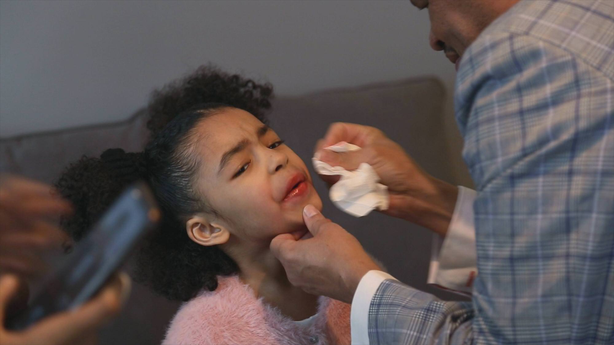 young flower girl has lipstick smudged